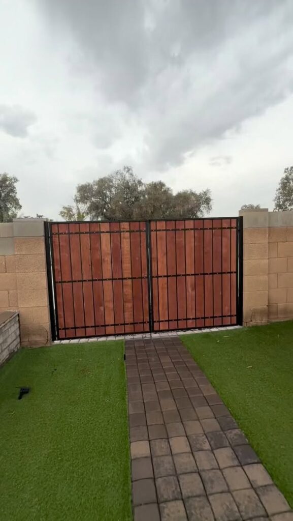 Wood and metal privacy fence with integrated door