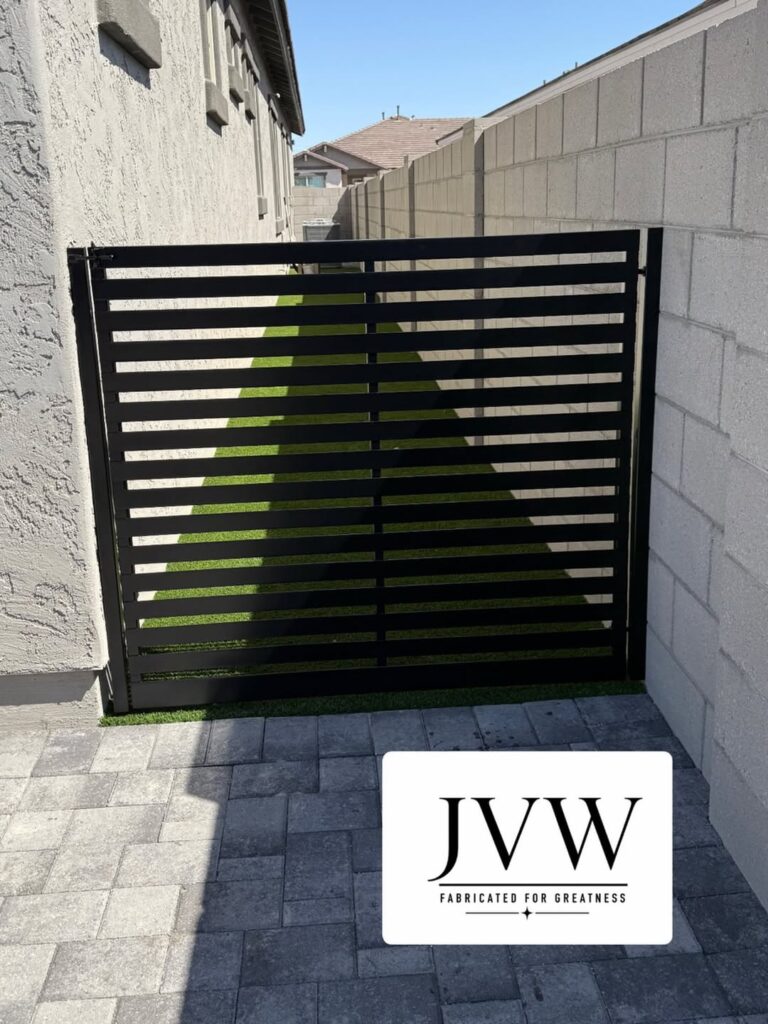 Modern black slat driveway gate