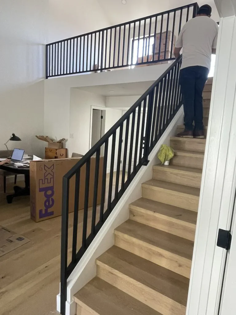 Interior wood staircase with black metal railing
