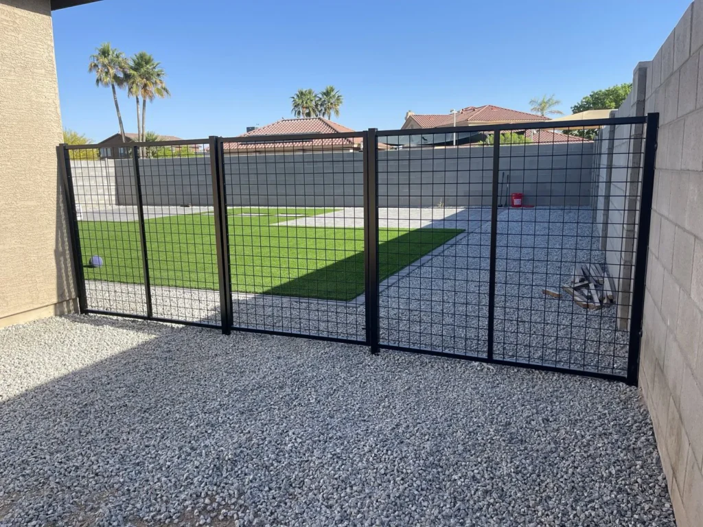 Black wire mesh fence enclosing a yard
