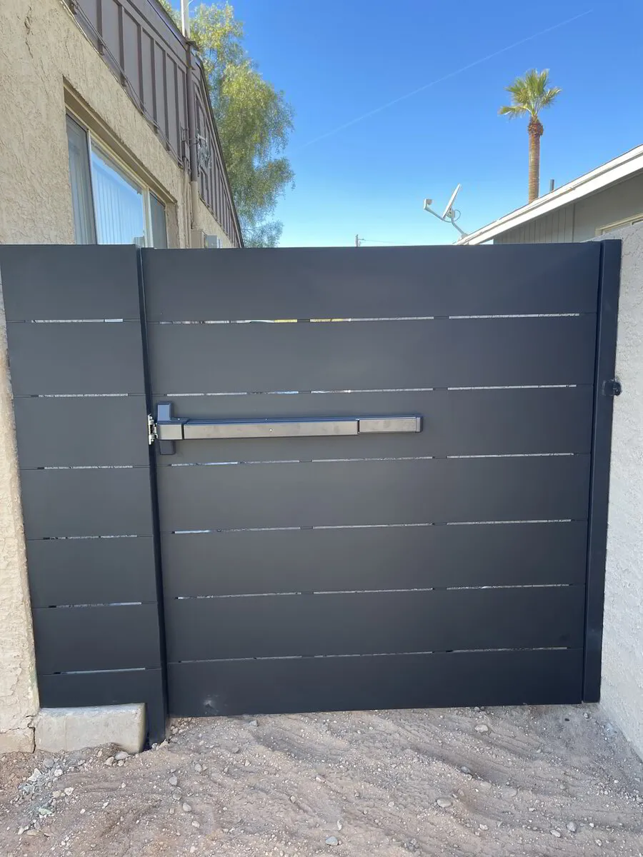 Modern black paneled gate at a home entry