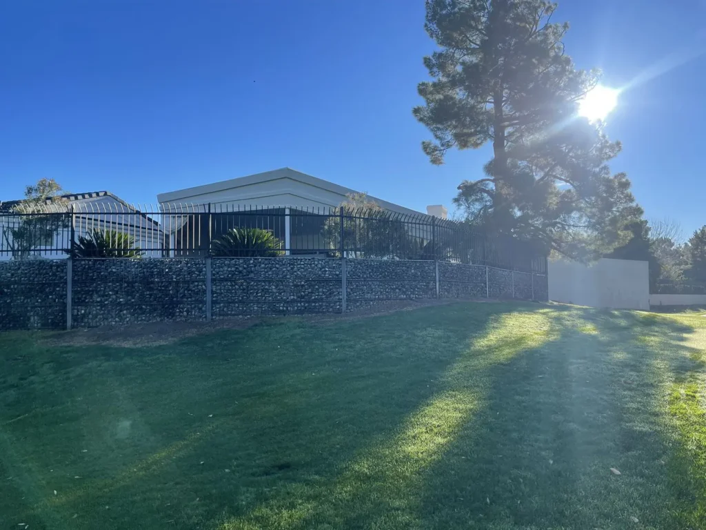 Metal fence and patio cover in a backyard