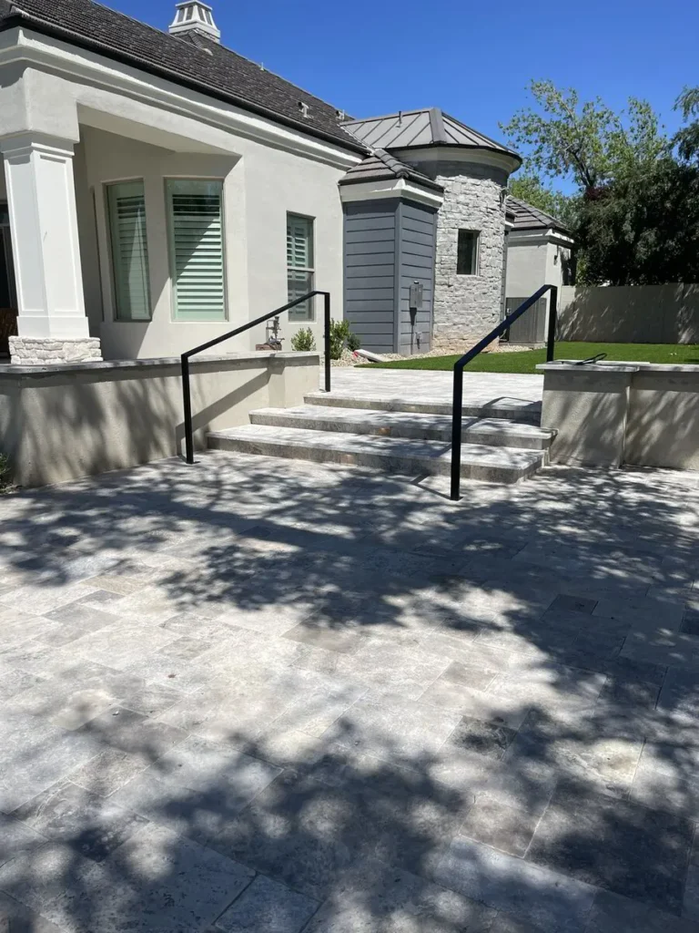 Exterior stairs with black metal railing leading to entry