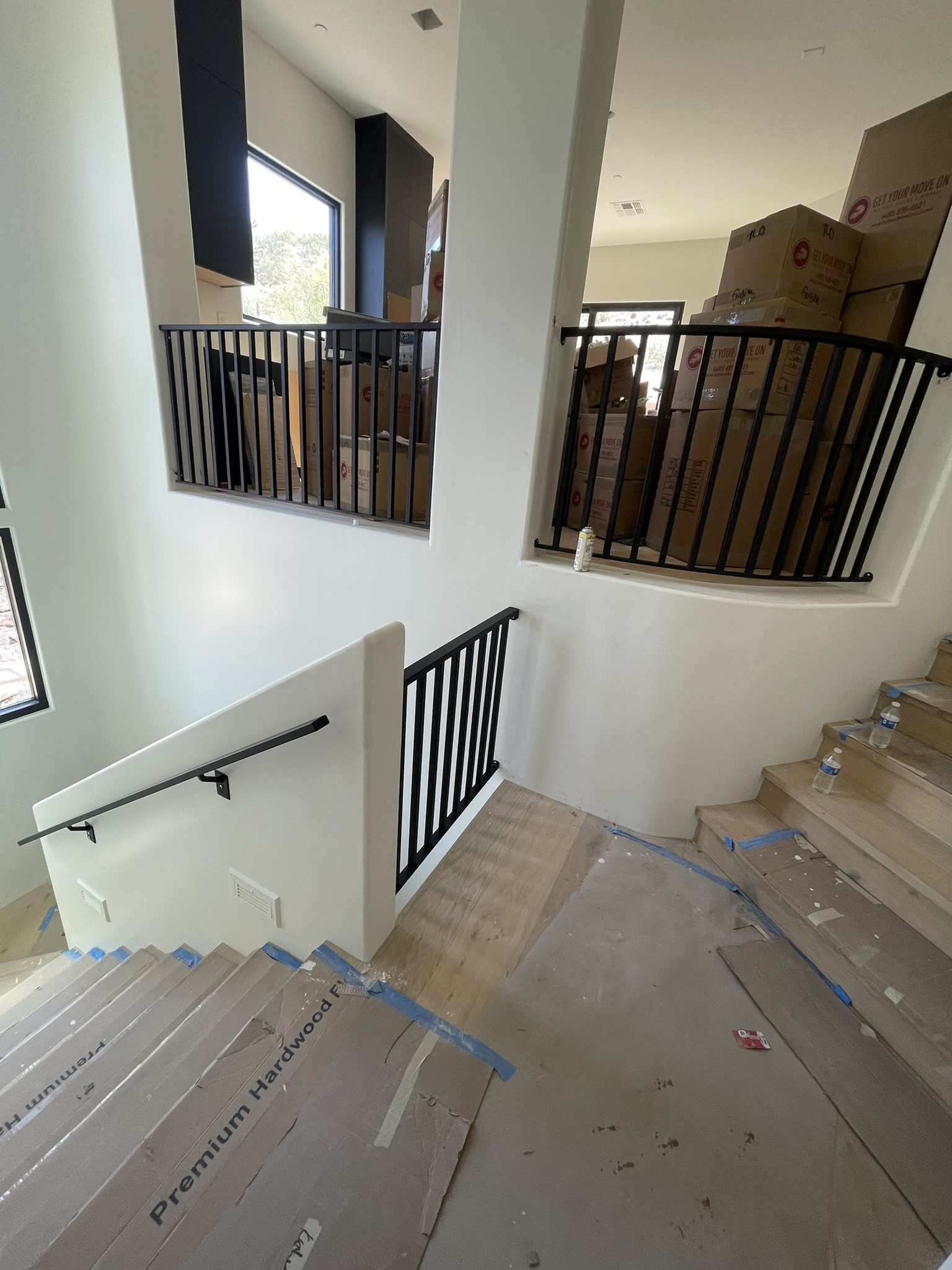 Curved interior staircase with black metal railing