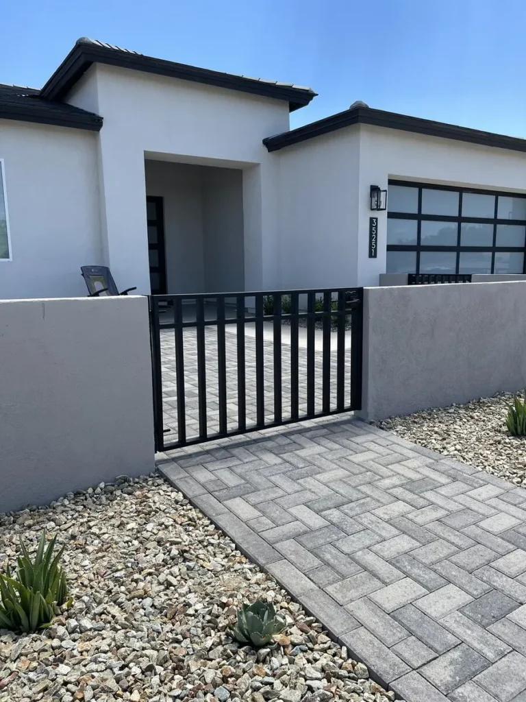 Black metal pedestrian gate in courtyard fence