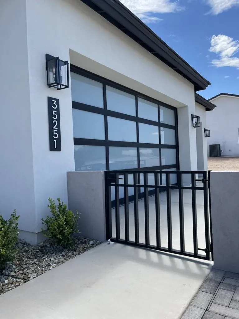 Modern black gate and garage entry combo