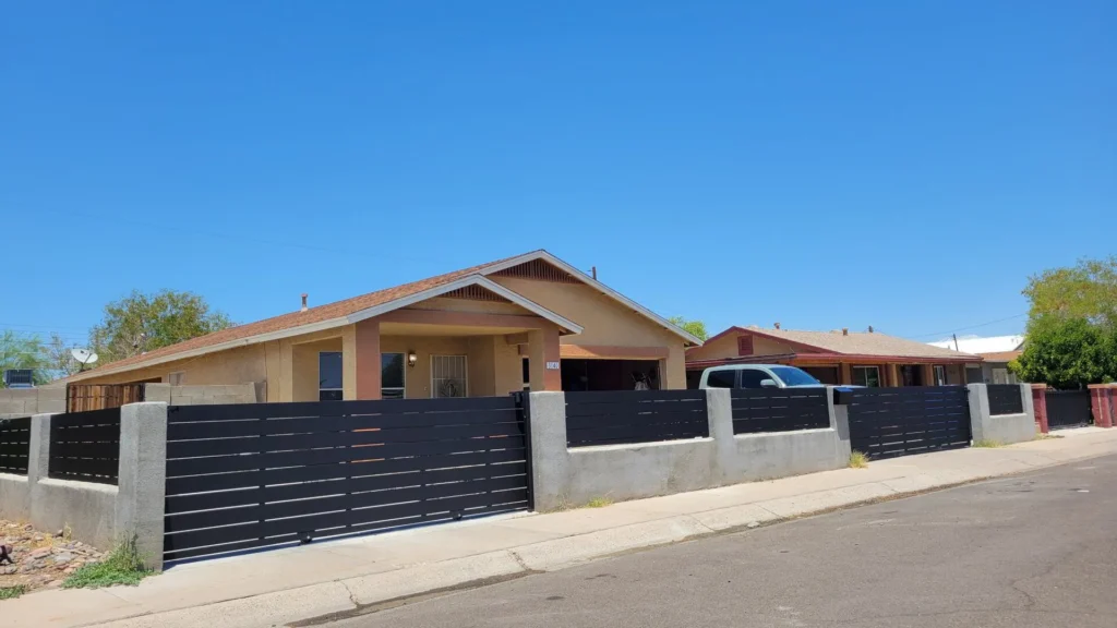 Black modern fence and gate at a home exterior